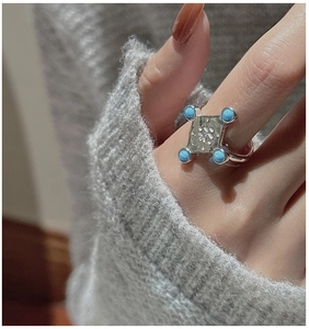 Detailed view of an S925 silver vintage ring with turquoise beads and engraved character