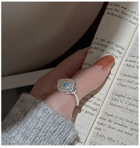 Macro detail of retro S925 silver ring with turquoise flower design and vintage textures