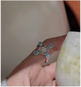Macro shot of S925 silver ring featuring turquoise stones and vintage Longevity character