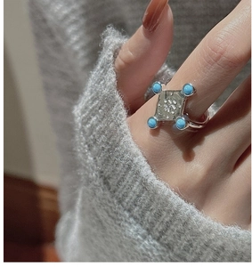 Detail of S925 silver ring featuring turquoise stones and a vintage tea character engraving
