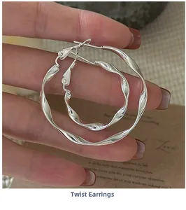 Close-up of S925 sterling silver twisted wave hoop earrings in two sizes with metallic shine