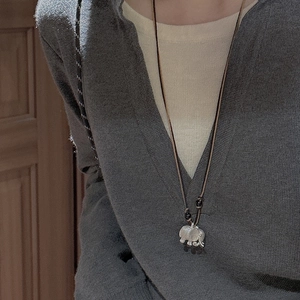 Minimalist S925 sterling silver elephant necklace with dark cord on model for lifestyle look