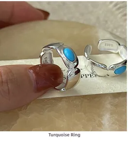 Detailed close-up showing S925 silver hallmark and oval turquoise stone on open ring