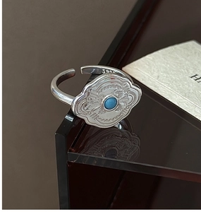 Macro detail of S925 sterling silver ring with blue turquoise and vintage wavy texture