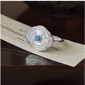 Macro detail of S925 silver ring with turquoise gemstone and ethnic floral carvings