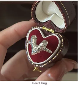 Detailed view of S925 silver ring with CNC texture in a red heart-shaped velvet box