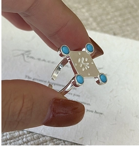 Macro view of vintage silver S925 ring with tea character engraving and turquoise