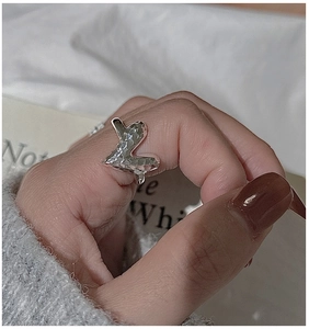 Detailed macro view of S925 sterling silver ring with hammered texture and geometric design