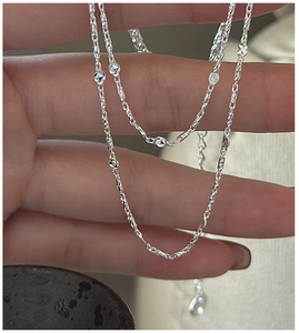 Macro shot of S925 sterling silver chain with diamond-cut beads on a twisted link necklace