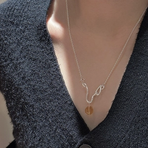S925 sterling silver necklace with vintage amber crystal pendant on a black knit sweater