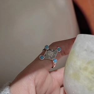 Retro S925 silver ring featuring turquoise stones and an engraved diamond-shaped totem