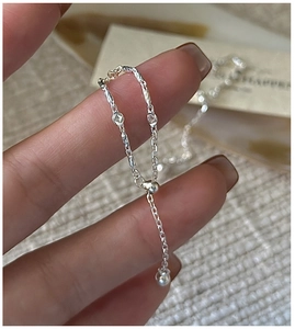 Macro detail of S925 sterling silver chain ring with adjustable slide bead closure