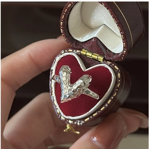Macro detail of S925 sterling silver faceted V-ring presented in a heart-shaped velvet box