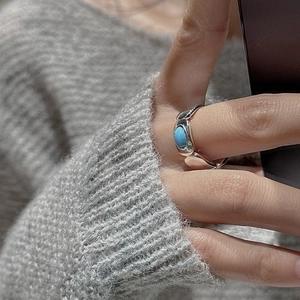 Minimalist S925 silver ring featuring a blue oval turquoise stone on model finger
