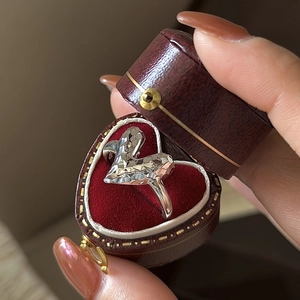 Sparkling S925 sterling silver geometric faceted ring in a heart-shaped red jewelry box