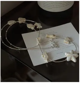 Detailed shot of S925 silver beaded long necklace with white star and fish charms