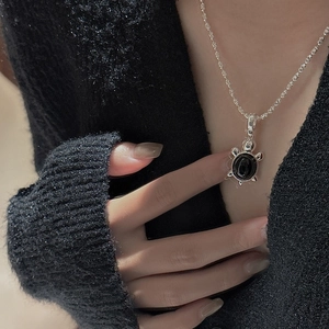 Collier minimaliste en argent sterling S925 avec pendentif tortue sur tricot noir élégant