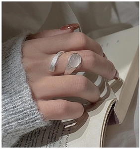 Macro detail of retro S925 sterling silver ring with brushed finish and oval gemstone