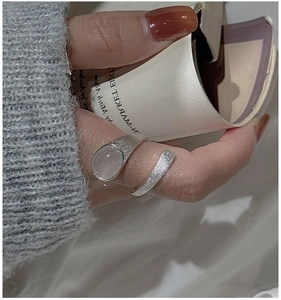 Detail of brushed S925 sterling silver ring featuring a large oval translucent stone