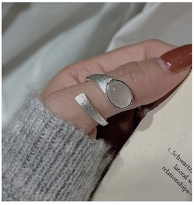 Macro shot of S925 silver ring featuring brushed texture and oval translucent stone inlay