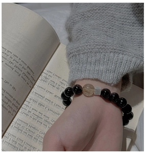 Detail of silver brushed cube and black agate beads on a minimalist S925 silver bracelet