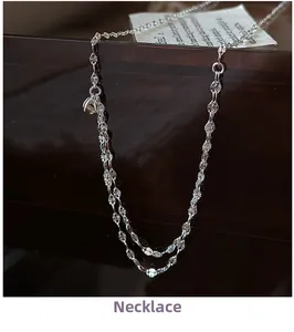 Detail view of S925 sterling silver petal texture chain on a professional display stand