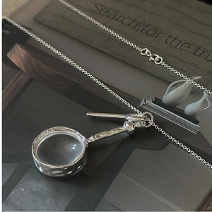Detail view of S925 sterling silver magnifying glass pendant with vintage hammered finish