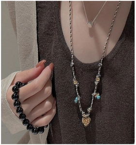 Détail du collier nomade en argent S925 avec pendentif pomme de pin et perles turquoise
