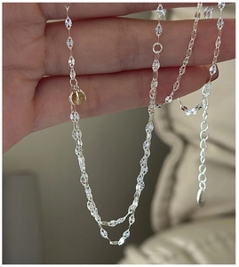Macro detail of S925 sterling silver chain with yellow citrine bead and S925 hallmark
