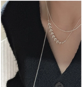 Detailed close-up of S925 sterling silver wheat ear Y-necklace on a model