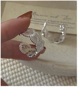 Close-up of S925 sterling silver hoop earrings with intricate retro lace texture detail