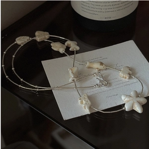 Detail of S925 silver long sweater chain with star fish and butterfly marble charms