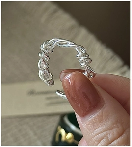 Detailed view of S925 sterling silver ring with hand-wound twisted texture and open band
