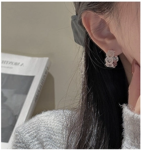 Detail of S925 sterling silver hoop earring with vintage lace texture worn on model