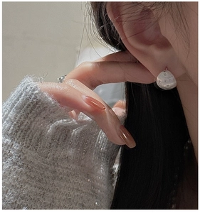 Detailed close-up of S925 silver brushed star earrings with tiny zircon accents