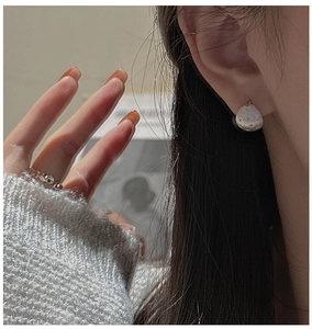 Detail of vintage brushed S925 sterling silver hexagram earring on female model