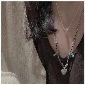 Détail du collier en argent S925 avec perles turquoise et pendentif feuille sur cordon