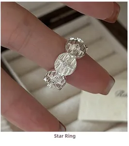 Detailed view of S925 silver star ring featuring sparkling stones on a velvet jewelry box