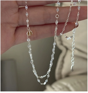 Detailed macro view of S925 sterling silver chain with a round yellow crystal pendant
