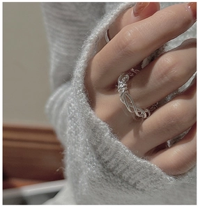 Close-up of S925 sterling silver woven ring with vintage texture on a hand model