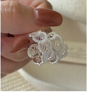 Detailed view of S925 sterling silver ring with delicate lace texture and cutout design
