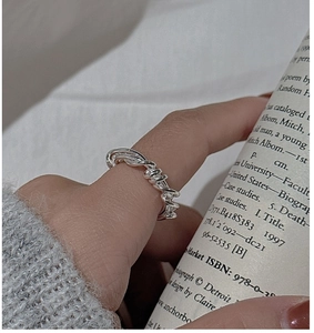 Macro view of twisted rope silver ring with spiked textures in a minimalist industrial style