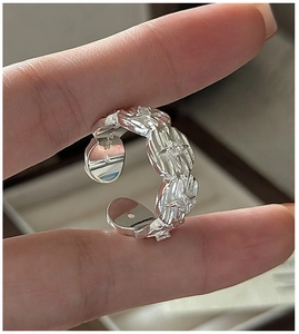 Detail of S925 sterling silver ring with wave texture, star pattern and zircon inlay