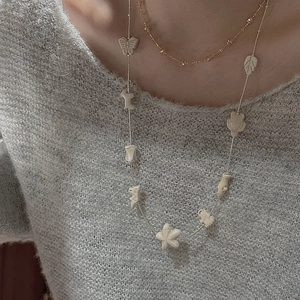 Minimalist S925 silver long sweater necklace featuring white ceramic animal charms on a model