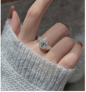 Macro shot of S925 silver ring with oval zircon and unique textured lava finish