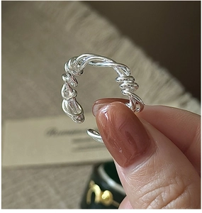 Close-up of twisted S925 sterling silver multilayer ring with minimalist winding design