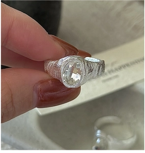 Macro detail of hand-hammered texture S925 silver ring with large oval cut zircon