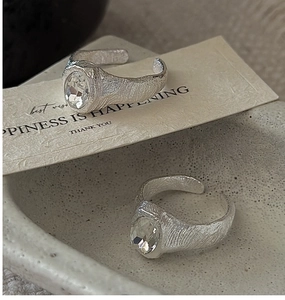 Macro detail of silver S925 rings with hammered texture and oval cubic zirconia stones
