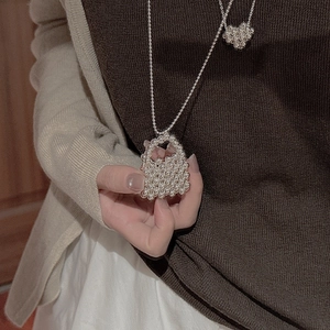 Minimalist S925 sterling silver beaded handbag necklace shown on model's hand