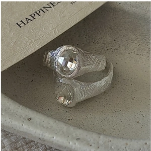 Macro detail of silver S925 rings featuring lava texture and oval zircon stones
